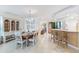 Dining area with wooden table, white hutch, breakfast bar, and tiled floors at 5000 Gasparilla Rd # 43-A, Boca Grande, FL 33921