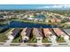 Aerial view of a beautiful home with water view in a well-maintained community at 5015 Seagrass Dr, Venice, FL 34293