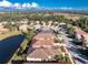 Beautiful aerial view of a single-Gathering home near a pond in a well-manicured community with mature trees and landscaping at 5015 Seagrass Dr, Venice, FL 34293