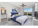 Stylishly decorated bedroom featuring a lake view, blue headboard, ensuite bathroom, and plush carpeting at 5015 Seagrass Dr, Venice, FL 34293