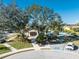 Community clubhouse adjacent to the swimming pool with parking and mature landscaping at 5015 Seagrass Dr, Venice, FL 34293