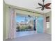 Living area with sliding glass doors leading to a scenic patio at 5015 Seagrass Dr, Venice, FL 34293