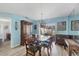 Charming dining room with wood table and chairs, leading to backyard at 611 Pineneedle Ln, Englewood, FL 34223