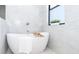 Bathroom with a free standing bathtub and marble tile at 6191 Kambach St, Port Charlotte, FL 33981