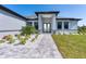 Inviting front entry with a paved walkway and nicely landscaped garden at 6192 Kambach St, Port Charlotte, FL 33981