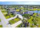 Aerial view showcasing the property, driveway, lush lawn, and nearby canal at 646 Boundary Blvd, Rotonda West, FL 33947