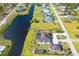 An aerial view of a house with a pool next to a canal at 646 Boundary Blvd, Rotonda West, FL 33947
