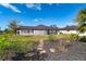 Spacious backyard with a metal roof, stepping stones, and lush greenery at 646 Boundary Blvd, Rotonda West, FL 33947