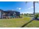 View of the backyard, pool, and canal from the lawn at 646 Boundary Blvd, Rotonda West, FL 33947