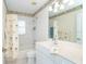 Clean bathroom with white vanity, shower/tub combo, and tropical-themed decor at 646 Boundary Blvd, Rotonda West, FL 33947