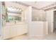 Bright bathroom with a glass-enclosed shower, vanity, and tiled flooring at 646 Boundary Blvd, Rotonda West, FL 33947