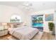 Bedroom with a ceiling fan, access to a lanai, and pool views at 646 Boundary Blvd, Rotonda West, FL 33947