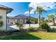 Side view of a house with a metal roof, solar panels, and lush greenery at 646 Boundary Blvd, Rotonda West, FL 33947