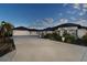 Large home with a three-car garage and circular driveway at 646 Boundary Blvd, Rotonda West, FL 33947