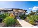 Inviting front entry with a paved walkway and lush landscaping at 646 Boundary Blvd, Rotonda West, FL 33947