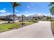 Spacious front yard with palm trees and a three-car garage under a bright blue sky at 646 Boundary Blvd, Rotonda West, FL 33947