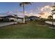 Beautiful home with a metal roof, landscaped yard, and palm trees at 646 Boundary Blvd, Rotonda West, FL 33947