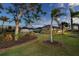 Home with a metal roof, palm trees, and lush landscaping at 646 Boundary Blvd, Rotonda West, FL 33947