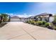 A beautiful house with a long driveway, landscaped yard, and palm trees under a clear sky at 646 Boundary Blvd, Rotonda West, FL 33947