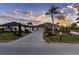 Home with a tile roof, large driveway, and lush landscaping at sunset at 646 Boundary Blvd, Rotonda West, FL 33947
