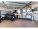 Spacious garage interior with a motorcycle, workbench, and storage cabinets at 646 Boundary Blvd, Rotonda West, FL 33947
