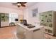 Bright home office with white furniture, built-in shelving, and a ceiling fan at 646 Boundary Blvd, Rotonda West, FL 33947
