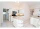 Spacious kitchen with white cabinets, an island, and a view of the laundry room at 646 Boundary Blvd, Rotonda West, FL 33947