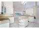Open kitchen with white cabinetry, a center island, and views of a dining area at 646 Boundary Blvd, Rotonda West, FL 33947