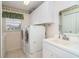 Laundry room with washer, dryer, sink, and ample cabinet space at 646 Boundary Blvd, Rotonda West, FL 33947