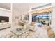 Living room with white furniture, high ceilings, and sliding glass doors to the pool area at 646 Boundary Blvd, Rotonda West, FL 33947