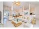 Open living room with white furniture, high ceilings, and views of the dining area at 646 Boundary Blvd, Rotonda West, FL 33947