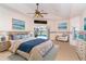 Main bedroom with a ceiling fan, pool view, and ensuite bathroom access at 646 Boundary Blvd, Rotonda West, FL 33947