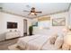 Main bedroom featuring wood-look floors, a ceiling fan, and ensuite bathroom at 646 Boundary Blvd, Rotonda West, FL 33947