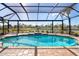 Inviting pool with a screened enclosure and water feature at 646 Boundary Blvd, Rotonda West, FL 33947