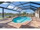 Screened-in pool and patio area with serene water views at 646 Boundary Blvd, Rotonda West, FL 33947