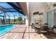 Screened lanai with pool, patio furniture, and access to the home at 646 Boundary Blvd, Rotonda West, FL 33947