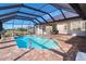 Screened pool area with a view of the backyard and home at 646 Boundary Blvd, Rotonda West, FL 33947