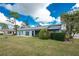 Home with grassy backyard and patio at 691 Linden Dr, Englewood, FL 34223
