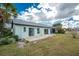 Home with grassy backyard and patio at 691 Linden Dr, Englewood, FL 34223