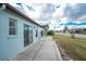 Home with grassy backyard and patio at 691 Linden Dr, Englewood, FL 34223