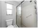 Bathroom with walk-in shower, tile flooring, and updated fixtures at 691 Linden Dr, Englewood, FL 34223
