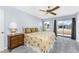 Bedroom with ceiling fan, carpeted flooring, and sliding glass doors that offer outdoor views at 691 Linden Dr, Englewood, FL 34223