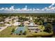 Aerial view of community pool, tennis, and shuffleboard courts at 691 Linden Dr, Englewood, FL 34223