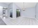 Bright dining room with tile flooring, chandelier, and sliding glass doors leading to the outdoor space at 691 Linden Dr, Englewood, FL 34223