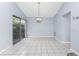 Dining room featuring tile flooring, a chandelier, and sliding glass doors that open to the backyard at 691 Linden Dr, Englewood, FL 34223