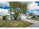 House with attached garage and mature landscaping at 691 Linden Dr, Englewood, FL 34223