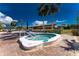 Clean and modern hot tub with surrounding lounge chairs and a covered pavilion in the background at 691 Linden Dr, Englewood, FL 34223