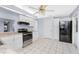 Kitchen features white cabinets, granite counters, and stainless steel appliances at 691 Linden Dr, Englewood, FL 34223