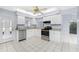 Bright kitchen with white cabinets and stainless steel appliances at 691 Linden Dr, Englewood, FL 34223