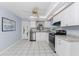 White kitchen cabinets, granite countertops, stainless steel appliances, and tile floors at 691 Linden Dr, Englewood, FL 34223